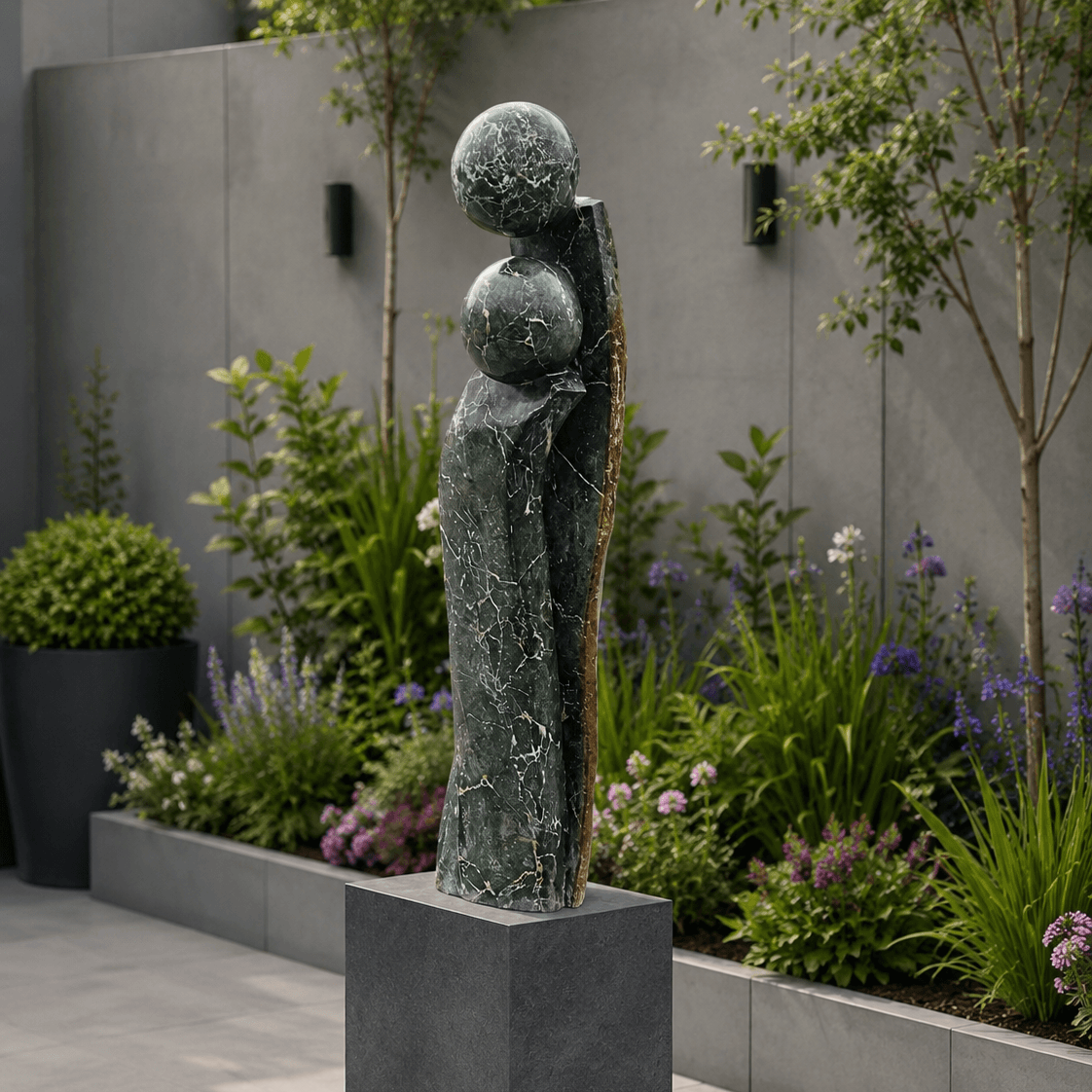 Decorative outdoor sculpture with spherical elements on a pedestal in a garden setting.