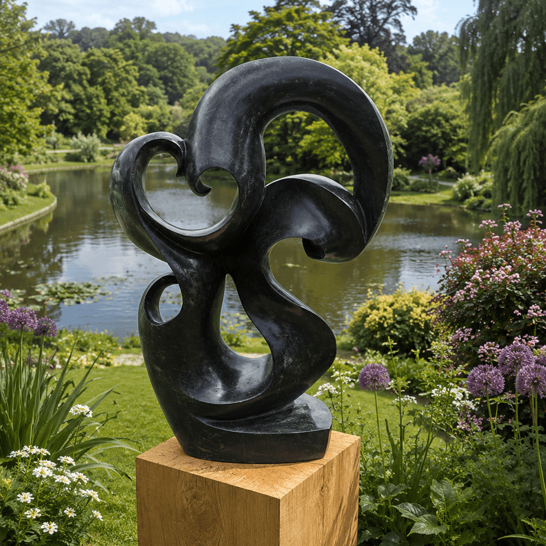 Abstract sculpture in a garden with a pond and trees in the background