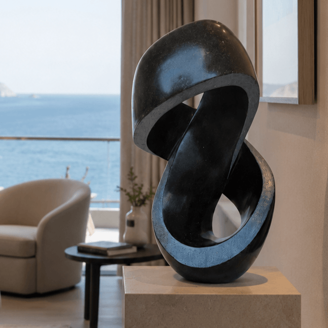 hand carved sculpture on a plinth in a  modern bedroom